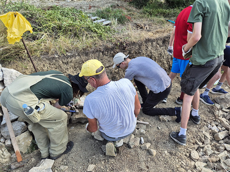 Team rebuilding a traditional dry stone wall during a corporate CSR event
