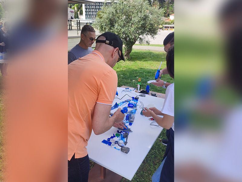 Employees creating artwork from recycled materials during a CSR workshop